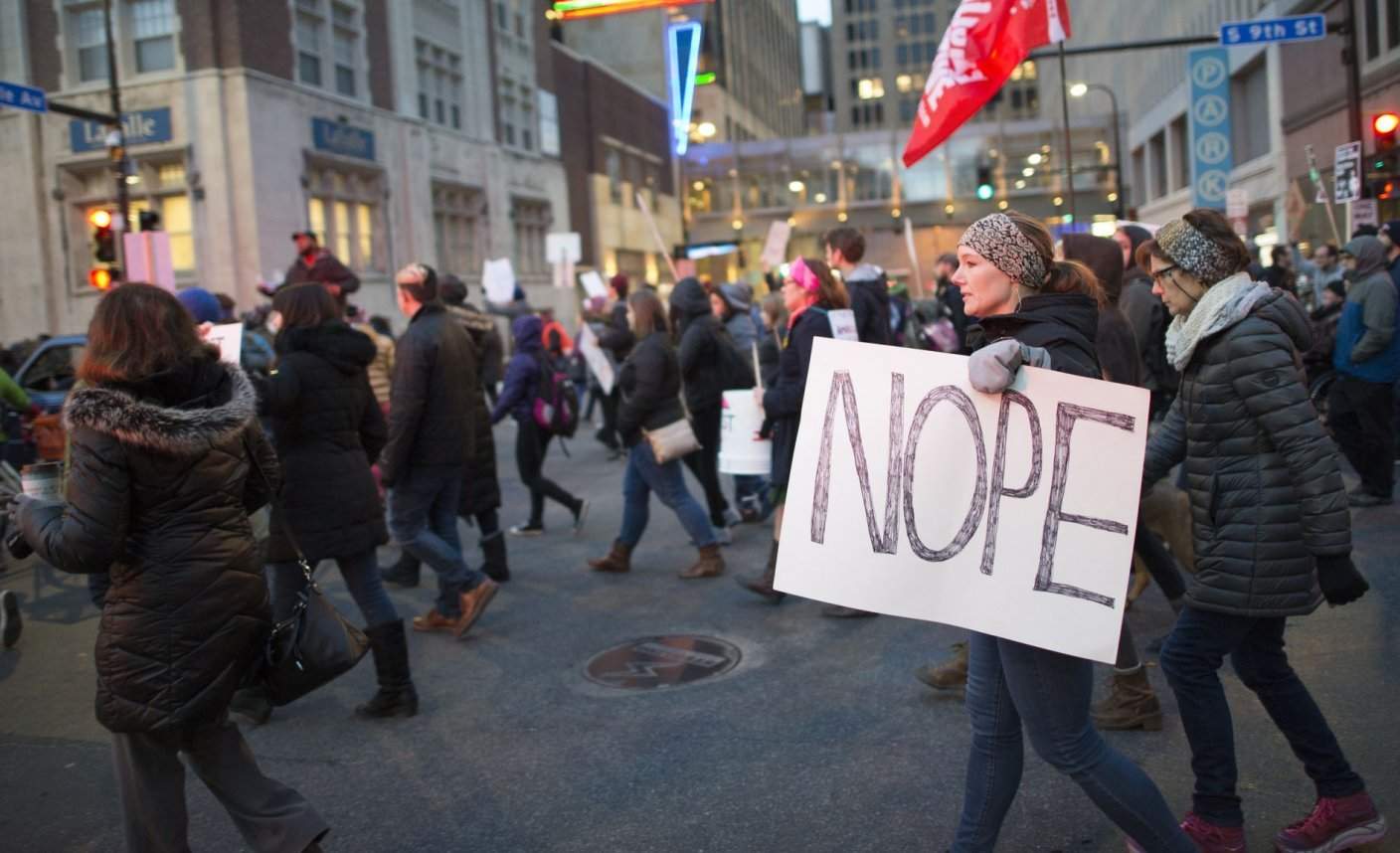 Protesters in Minneapolis holding a sign saying "Nope"